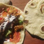 Homemade naan bread with chicken kebab, salad and garlic sauce