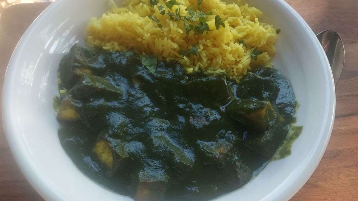 Homemade saag paneer with spinach and paneer served with yellow rice