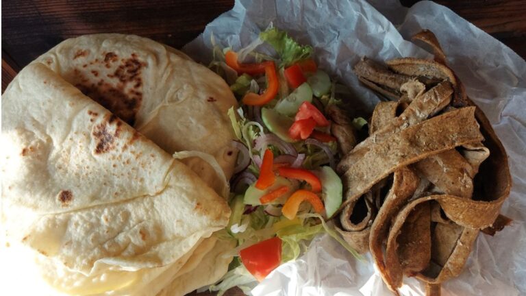Homemade kebab with flatbreads, seasoned meat and fresh salad
